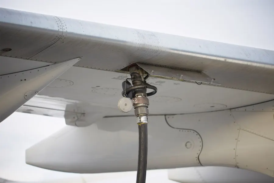 Fuel hose connected under an aircraft wing