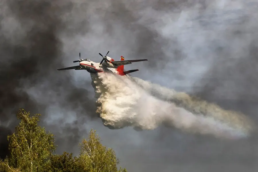 Air tanker dropping fire retardant over a wildfire