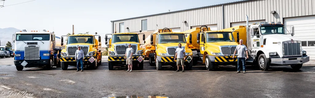 The Mammoth Fuels truck fleet lined up with its drivers outside the hangar